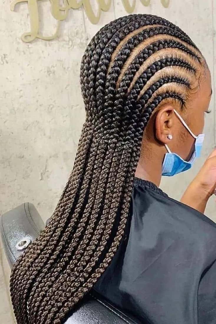 Fulani braids with side-swept cornrows, profile view